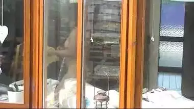 NRI house wife cleaning glass and showing naked figure