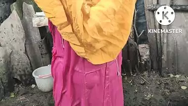 Indian house wife bathing outside