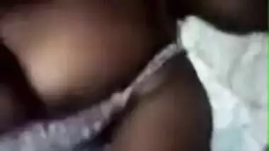 Tanned Desi girl lies in bed stripping XXX boobies for old pervert