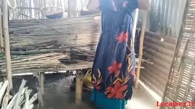 Bihari babu pounds his malkin outdoors in a hut