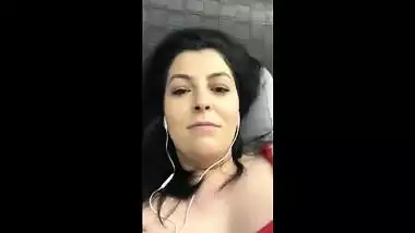 Playing with feet gives pleasure to Indian with earphones watching TV